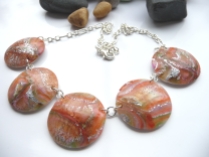 Polymer Clay disc necklace with Red Pepper, Citrus & Sunshine yellow inks mixed into the clay